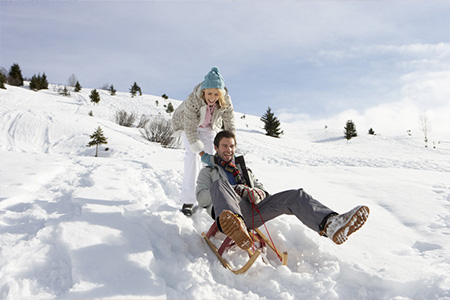 Young couple sledding