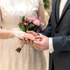 Groom and bride with beautiful ring and bouquet