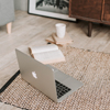 Laptop and books on floor carpet