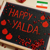 Happy Yalda night. Iranian traditional holiday. Pomegranate inscription on blackboard, flat lay.