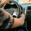 Two young men in a driving session. The instructor is teaching the young man to drive. The instructo