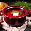 a clay pot filled with borscht ready to be served