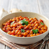 Spicy Chickpea curry Chana Masala in bowl on wooden table. Traditional Indian dish. Selective focus.