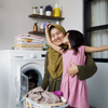 muslim asian mother and child girl little helper in laundry room