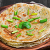 stack of aloo paratha on brown plate