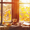 fall. cozy window with autumn leaves, a book, a mug of tea