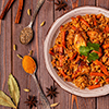 Pilaf (biryani) on a wooden background, top view,