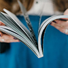 woman holding book, blurred background