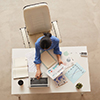  Top view background of businesswoman holding document while sitting at table, copy space