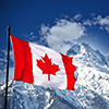 Mountains in Banff covered in snow - Canada flag in foreground