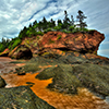 caves and coastal features at low tide of the Bay of Fundy at St. Martins, New Brunswick, Canada.