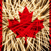 Fireworks in a heart shape with the Canada flag on a black background