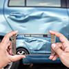 Close up hand of woman holding smartphone and take photo of car accident