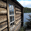 view of water behind log cabin