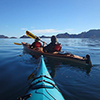 picture of two kayakers taken by author on kayak, mounains in background, taken in in Jasper Nationa