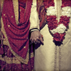 Pakistani wedding couple holding hands.