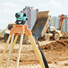 Surveying measuring equipment level theodolite on tripod at construction building area site