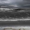 Fear written in sand on beach - stormy cloud and waters 