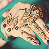 focus on woman's hands with henna wearing traditional indian sari