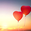 two red balloons in shape of heart on the background of sunset sky. the concept of love and Valentin