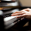Close up of a musician playing a piano keyboard