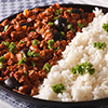 Picadillo a la habanera with a side dish of rice close-up on a plate