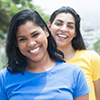 Two mexican girlfriends in colorful shirts in the city