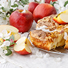 Freshly baked Apple pie on the table with apples, piece in plate