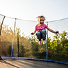 little kid jumping high on trampoline
