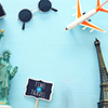 travel items - camera, hat, eiffel tower, statue of liberty