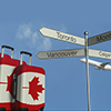 Travel baggage featuring flag of canada, airplane and city sign post. canadian tourism conceptual 3d