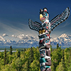 Isolated totem wood pole in mountain blue background