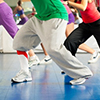 Young people only legs to be seen doing Zumba training or dance workout in a gym