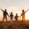 Happy family: mother, father, children son and daughter on sunset