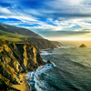 The coastline at Big Sur in california, with steep cliffs and rock stacks in the Pacific Ocean.