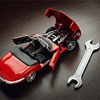 Concept of repair, A vibrant red sports car model rests on a polished wooden surface, its hood elega