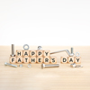 Wooden blocks with text on table with wrench, nuts and screws
