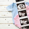 Pink and blue baby clothes waiting for new baby arrival