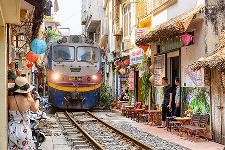 Incredible view of train passing through a narrow street, the Hanoi Old Quarter.