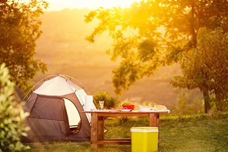 Tent set up with breakfast table at sunrise