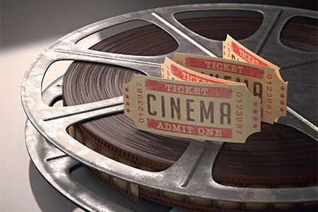 Cinema ticket over rolls of film; Concept