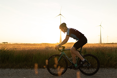 Cyclist on the racing bike at sunset