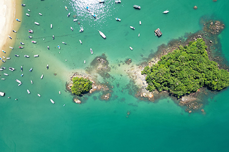 An aerial shot of boats on the sea on a sunny day in Angra dos Reis, Brazil