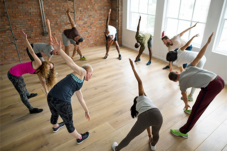 Diverse group of people excercising in a circle