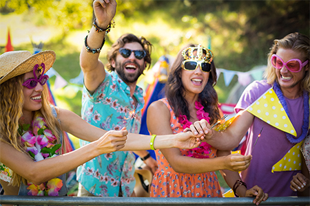 Friends dancing at music festival in park on a sunny day