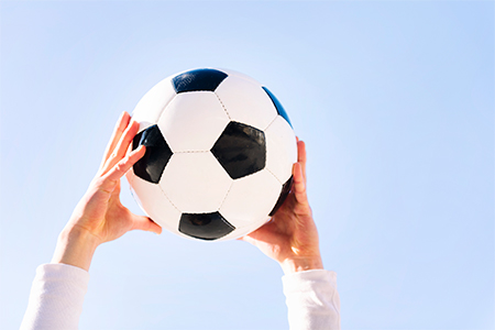 close up of hands holding a soccer ball, concept of football and sport, copy space for text