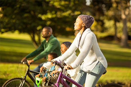 young family doing a bike ride on an autumns day