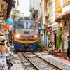  Incredible view of train passing through a narrow street, the Hanoi Old Quarter.