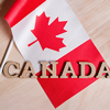 Flag of Canada, the word Canada in wooden abstract letters, wooden background