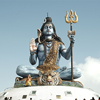 A majestic statue of Lord Shiva seated on a tiger skin against a clear sky, showcasing intricate det